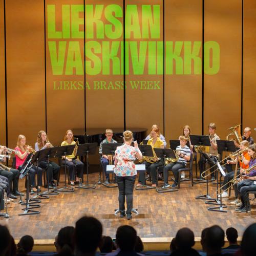 Brass orchestra is playing on a stage